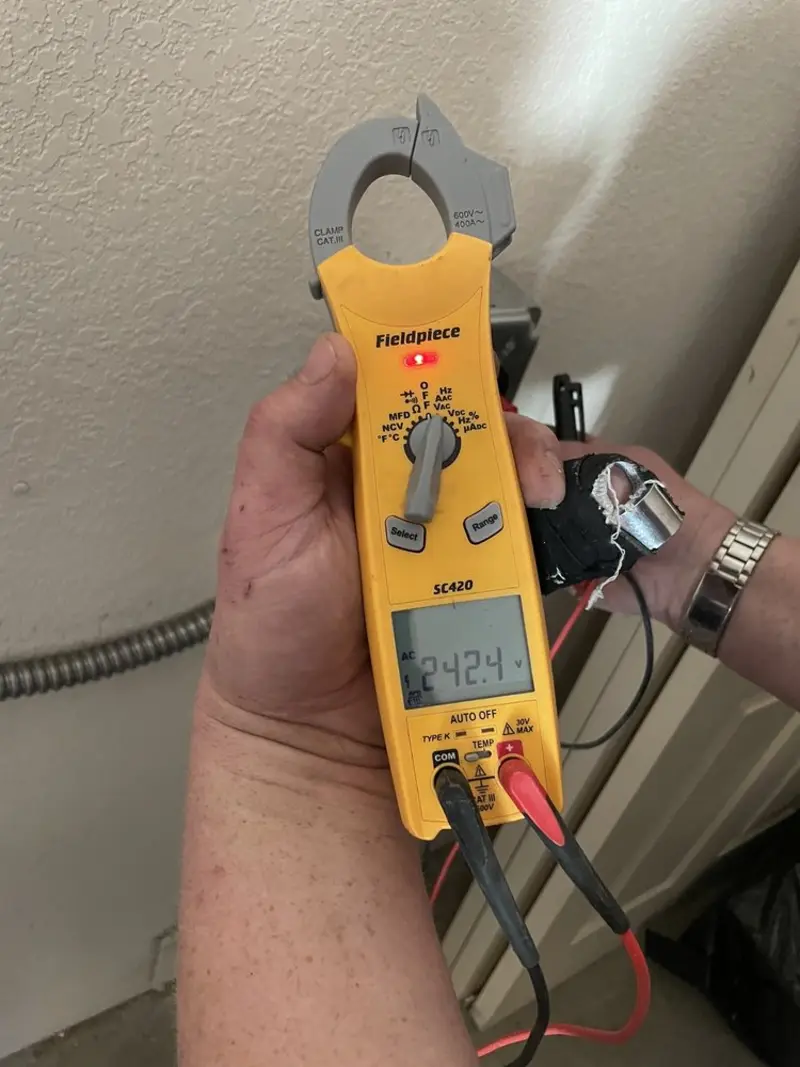 Voltage testing with clamp meter during Circuit Breaker Repair in Dallas